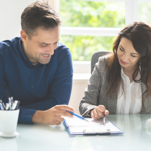 Two physicians reviewing a contract before one signs the employment agreement