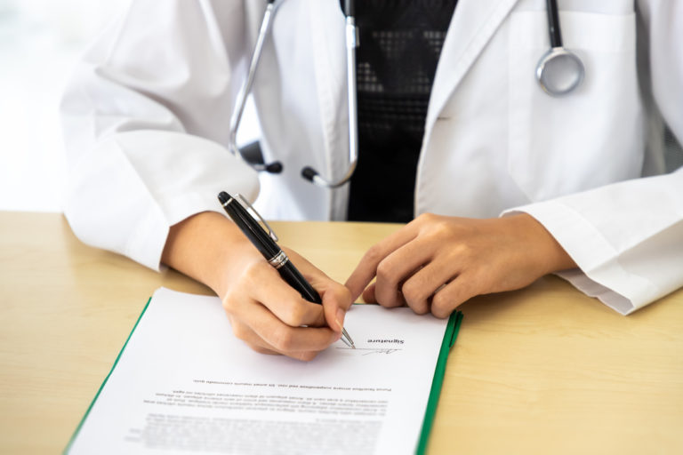 physician-signing-employment-contract-after-negotiation-is-completed