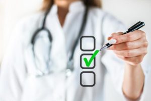 physician-checking-off-virtual-checklist-for-onsite-interview