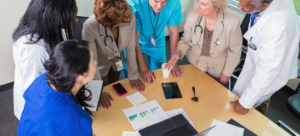 A physician leading a meeting with their colleagues after strategizing their career
