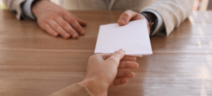 a physician giving their letter of resignation to their medical employer which now contributes to their high physician turnover rate