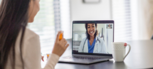 A patient talking to their remote physician at their online medical appointment