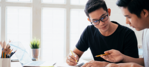 Two physicians working together to study for their upcoming board exams